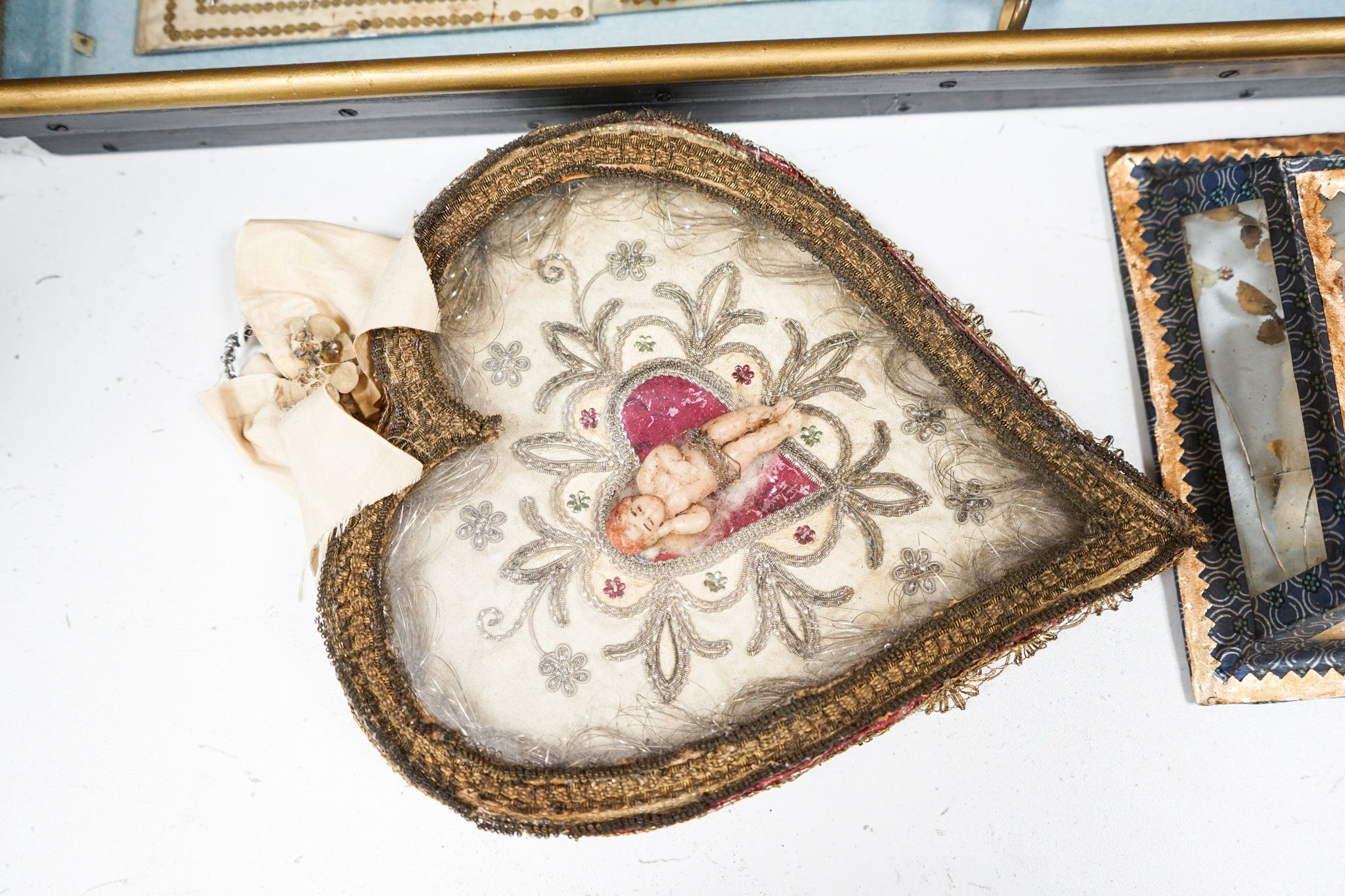 A late 18th / early 19th century Continental figurative framed fan and two religious cased effigy of baby Jesus